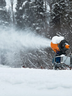 Snow cannon spraying out a fresh dusting of snow on the ski slopes