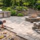 Hardscape contractors installing curved stone paver walkway
