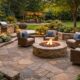 Natural stone patio installation with circular fire pit, outdoor seating, and landscaped backyard at dusk